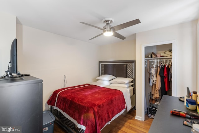 bedroom featuring wood finished floors, a closet, and a ceiling fan