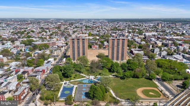 aerial view of property and surrounding area featuring nearby urban area