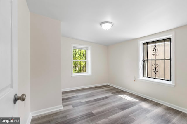 empty room with wood finished floors and baseboards