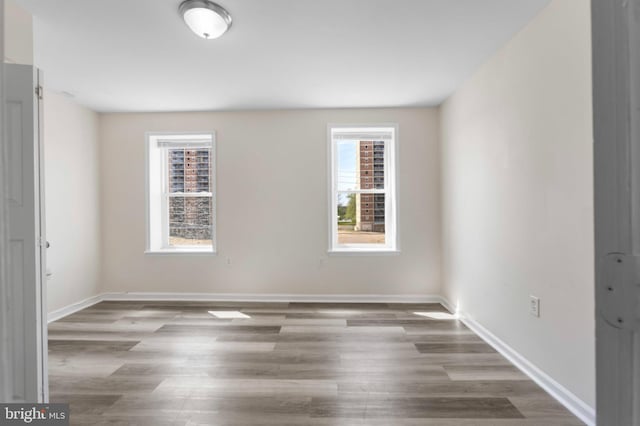 empty room with wood finished floors and baseboards