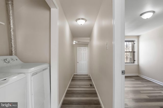 laundry room with separate washer and dryer, dark wood-style floors, and baseboards