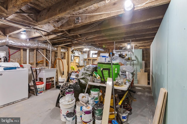 unfinished basement with washer / clothes dryer and a sink