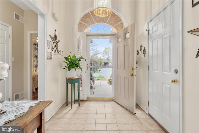 93 Radcliff Ln, Falling Waters, WV 25419 - foyer featuring light tile patterned floors, visible vents, a chandelier, and baseboards