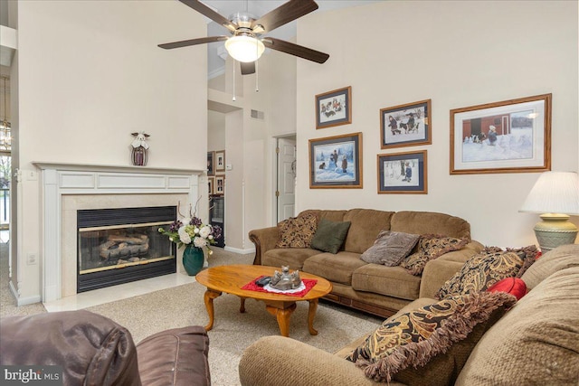 93 Radcliff Ln, Falling Waters, WV 25419 - living room featuring a high ceiling, a fireplace with flush hearth, a ceiling fan, visible vents, and baseboards