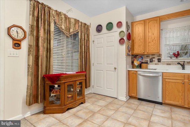 93 Radcliff Ln, Falling Waters, WV 25419 - kitchen featuring tasteful backsplash, stainless steel dishwasher, light countertops, a sink, and baseboards