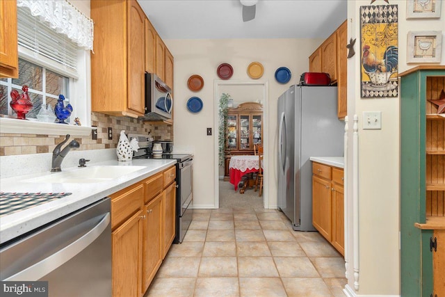 93 Radcliff Ln, Falling Waters, WV 25419 - kitchen featuring appliances with stainless steel finishes, light countertops, backsplash, a sink, and a ceiling fan