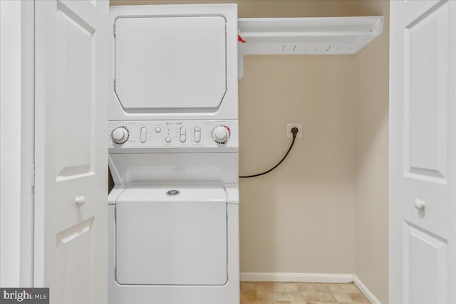 93 Radcliff Ln, Falling Waters, WV 25419 - laundry room featuring stacked washer / drying machine, laundry area, and baseboards