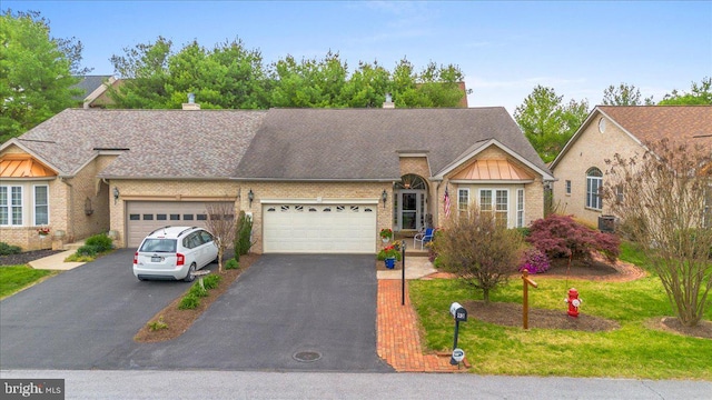 93 Radcliff Ln, Falling Waters, WV 25419 - view of front of home featuring driveway, a chimney, brick siding, and an attached garage