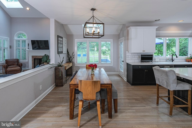 173 Christopher Dr, Princeton, NJ 08540 - dining space featuring plenty of natural light, a chandelier, a brick fireplace, recessed lighting, and lofted ceiling