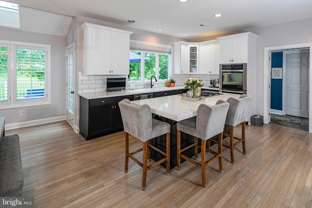 173 Christopher Dr, Princeton, NJ 08540 - kitchen with appliances with stainless steel finishes, white cabinets, a breakfast bar area, decorative backsplash, and recessed lighting