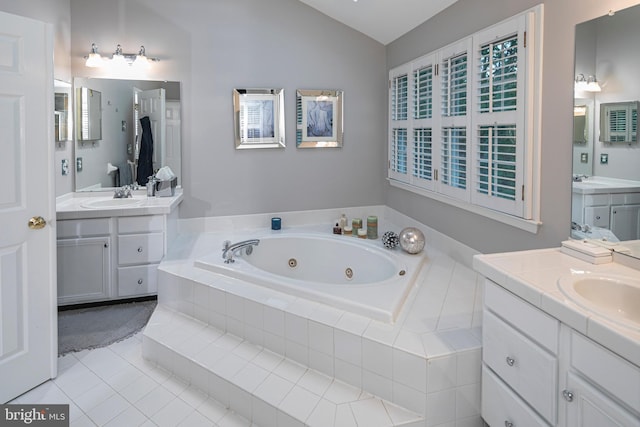 173 Christopher Dr, Princeton, NJ 08540 - bathroom featuring a jetted tub, vaulted ceiling, tile patterned flooring, and two vanities