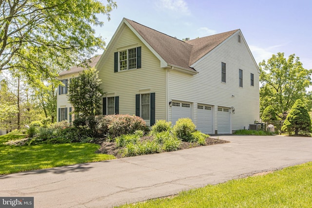 173 Christopher Dr, Princeton, NJ 08540 - view of home's exterior featuring a garage, asphalt driveway, roof with shingles, and a yard
