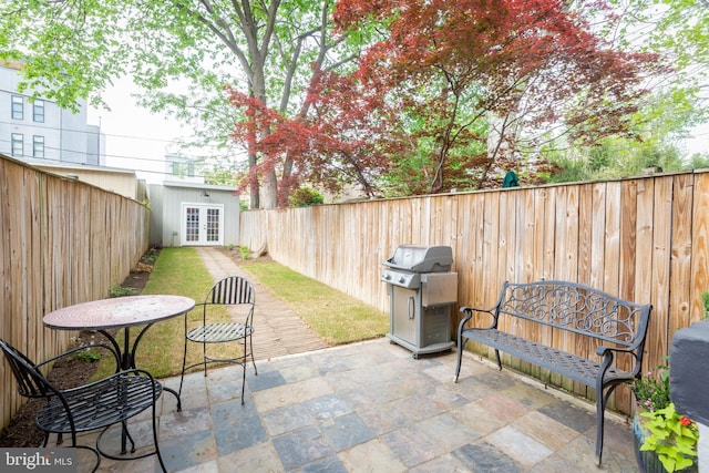 view of patio / terrace with a fenced backyard, french doors, and area for grilling