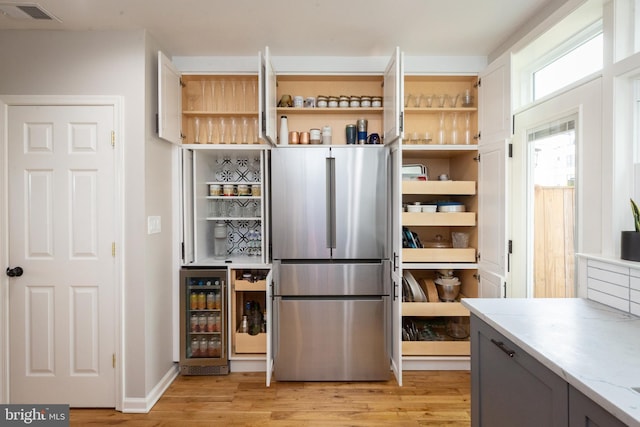 pantry with visible vents and wine cooler