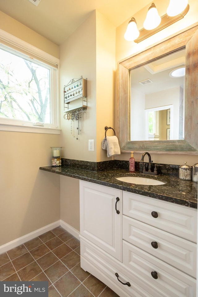 bathroom with baseboards, visible vents, tile patterned flooring, and vanity
