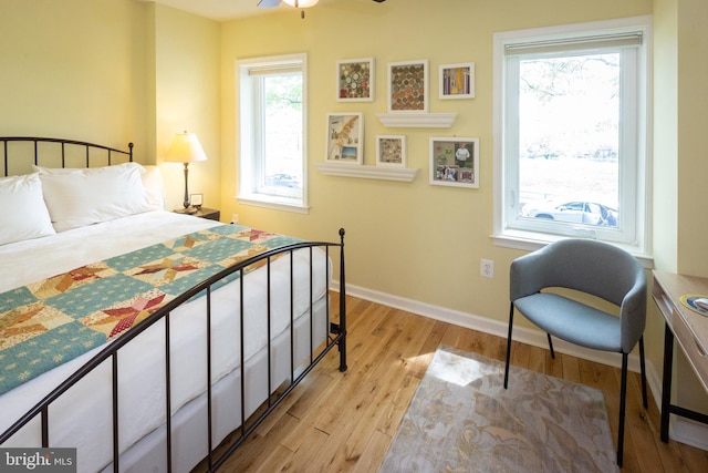 bedroom with baseboards and light wood-type flooring