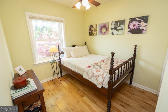 bedroom featuring light wood-style floors, baseboards, and multiple windows