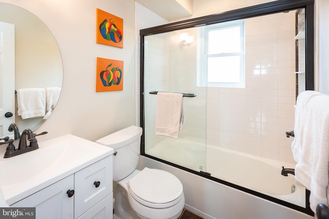 full bath with vanity, enclosed tub / shower combo, and toilet