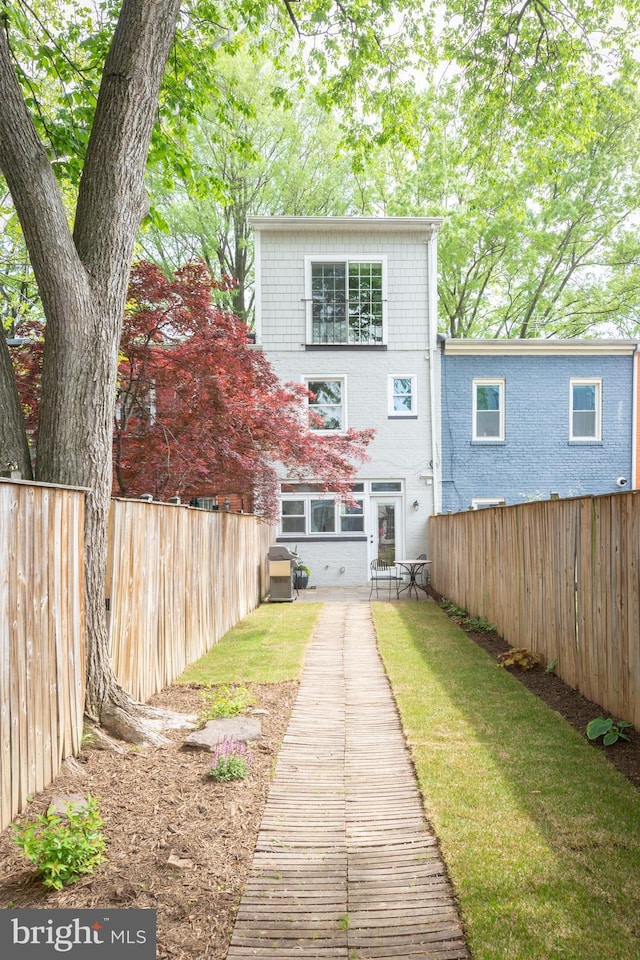 rear view of property featuring fence