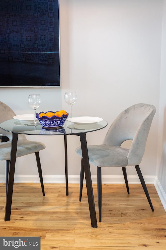 dining room featuring baseboards and wood finished floors