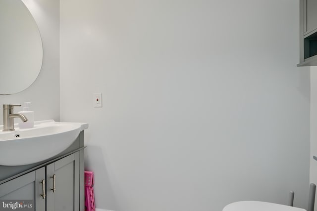 half bath featuring toilet and vanity