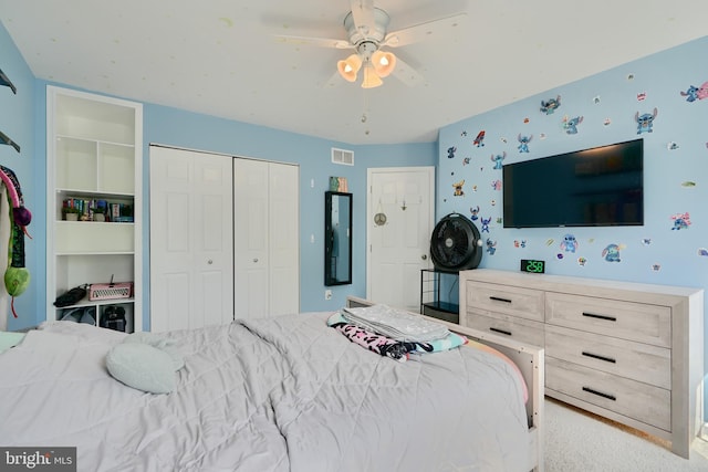 bedroom featuring ceiling fan, a closet, and visible vents
