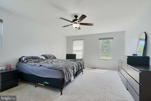 bedroom featuring baseboards, a ceiling fan, and carpet flooring