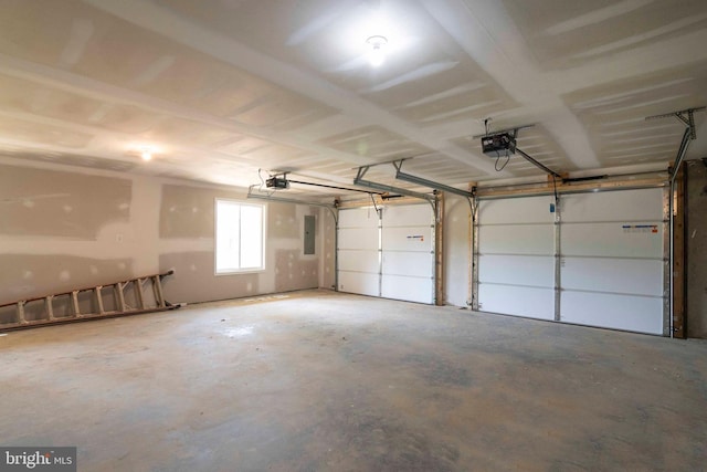 garage with electric panel and a garage door opener