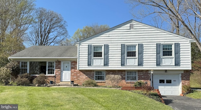 403 Leslie Ln, West Chester, PA 19382 - split level home featuring brick siding, asphalt driveway, a front lawn, and a garage