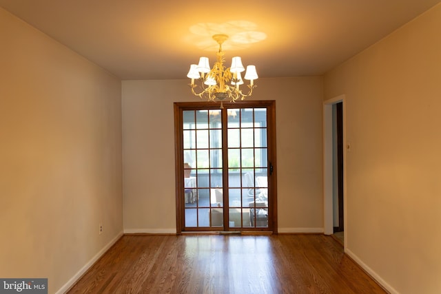 403 Leslie Ln, West Chester, PA 19382 - empty room with a chandelier, wood finished floors, and baseboards