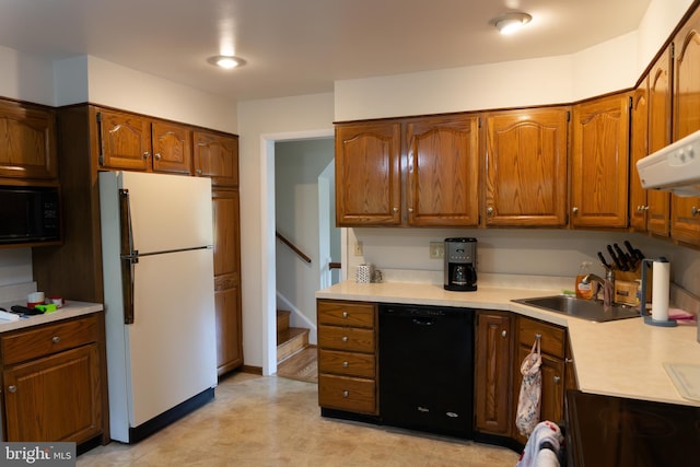 403 Leslie Ln, West Chester, PA 19382 - kitchen with black appliances, light countertops, a sink, and brown cabinets