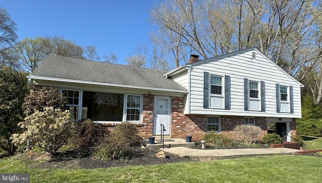 403 Leslie Ln, West Chester, PA 19382 - split level home with brick siding, a chimney, and a front yard