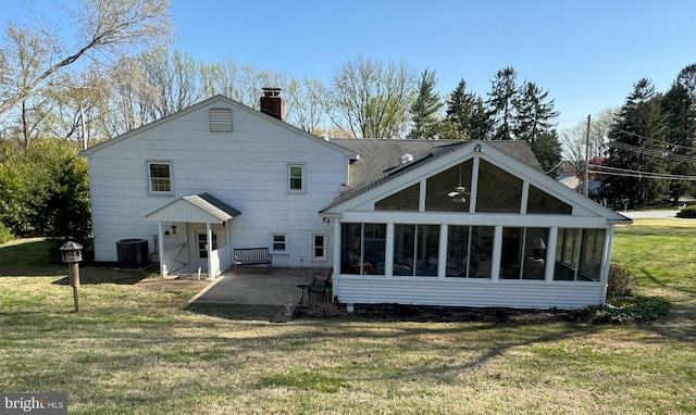 403 Leslie Ln, West Chester, PA 19382 - back of property with a sunroom, a patio area, a chimney, a yard, and cooling unit