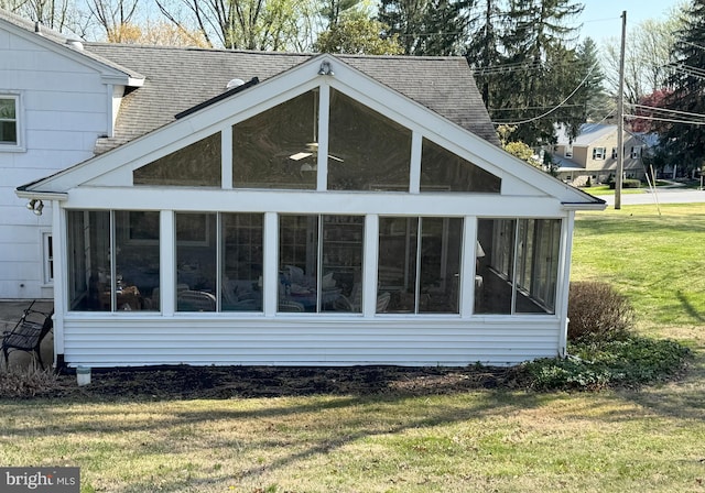 403 Leslie Ln, West Chester, PA 19382 - view of property exterior with a sunroom, a shingled roof, and a lawn