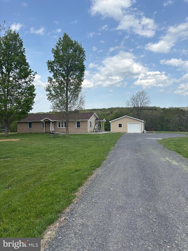 ranch-style house with an outdoor structure, a garage, and a front lawn