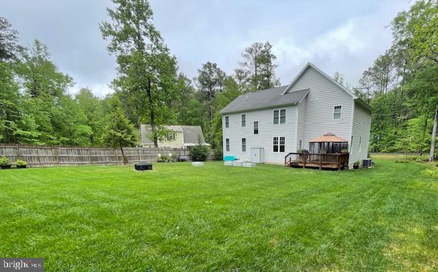 1 Stafford Cv, Ruther Glen, VA 22546 - rear view of property featuring a deck, a gazebo, fence, an outdoor fire pit, and a yard