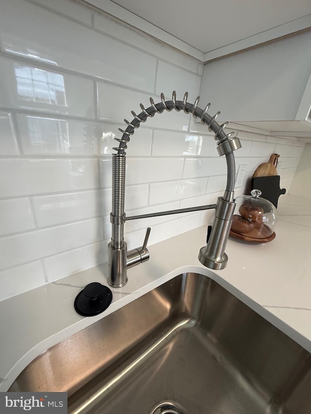 3724 Cedar Dr, Baltimore, MD 21207 - kitchen view of a sink, backsplash, and light countertops