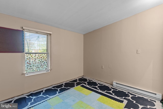 unfurnished bedroom with a baseboard heating unit