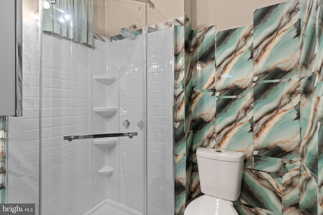 full bathroom featuring toilet and a stall shower
