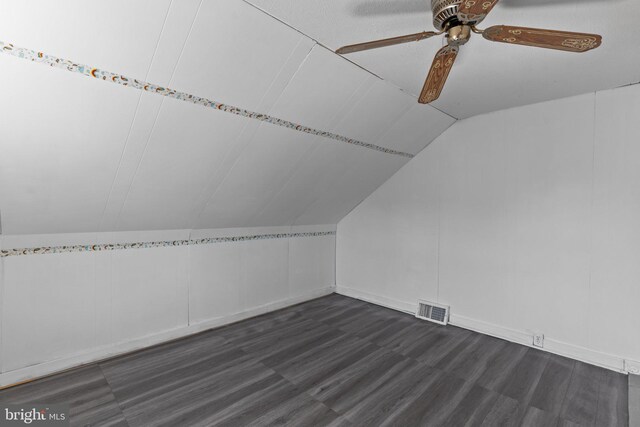 bonus room with ceiling fan, visible vents, dark wood finished floors, and vaulted ceiling
