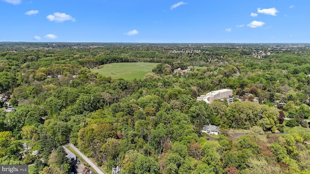 birds eye view of property with a view of trees