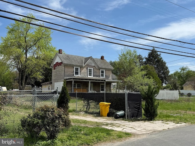 view of front of property with a chimney and a fenced front yard