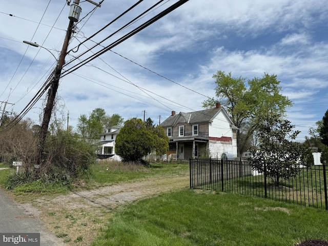 view of yard featuring fence and driveway