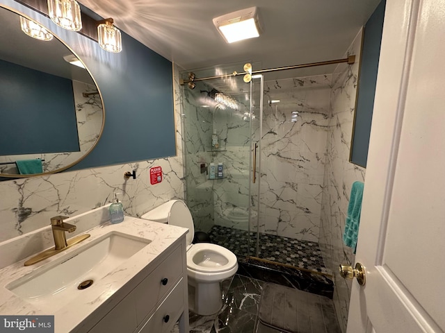 bathroom featuring tile walls, vanity, toilet, a marble finish shower, and marble finish floor