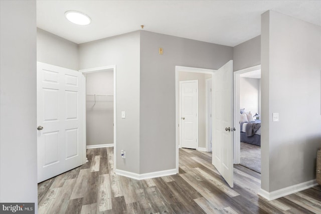 5386 Glenthorne Ct Unit 5386, Baltimore, MD 21237 - unfurnished bedroom featuring a closet, baseboards, wood finished floors, and a spacious closet