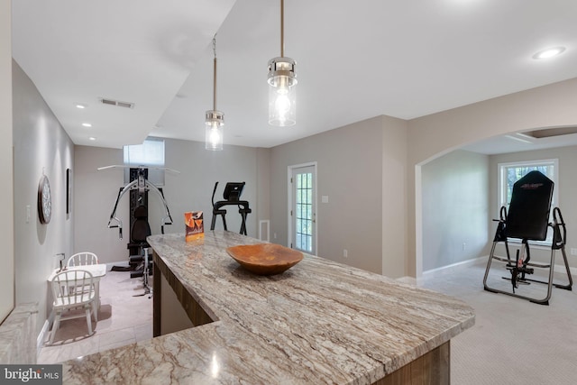 11294 Country Club Rd, New Market, MD 21774 - kitchen with arched walkways, baseboards, light stone counters, pendant lighting, and light colored carpet
