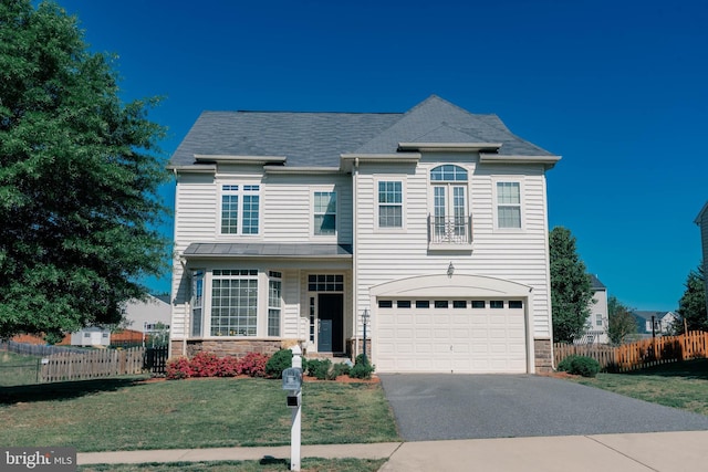 traditional home with fence, driveway, and stone siding