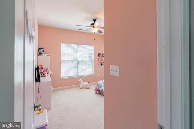 interior space with baseboards and a ceiling fan