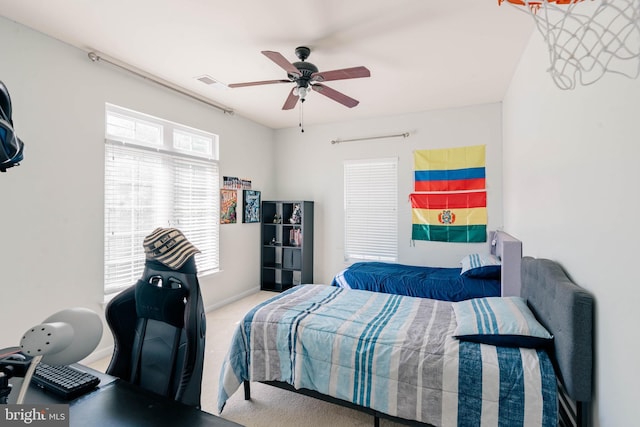 carpeted bedroom featuring visible vents and ceiling fan