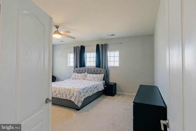 carpeted bedroom featuring a ceiling fan, baseboards, and visible vents